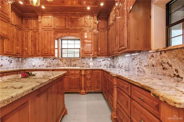 a kitchen with stainless steel appliances granite countertop a sink and cabinets