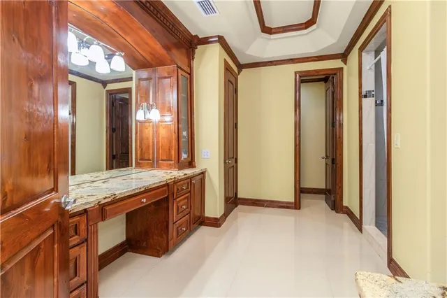 a spacious bathroom with a granite countertop sink mirror and shower