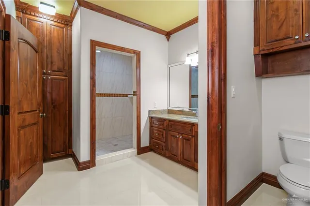 a bathroom with a granite countertop sink a large mirror and a shower