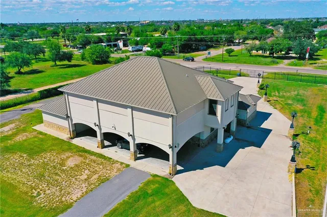 a view of a house with yard and a park