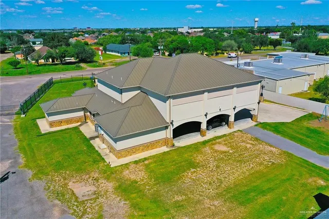 an aerial view of a house with garden space and street view