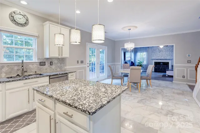 a kitchen with center island table and chairs in it