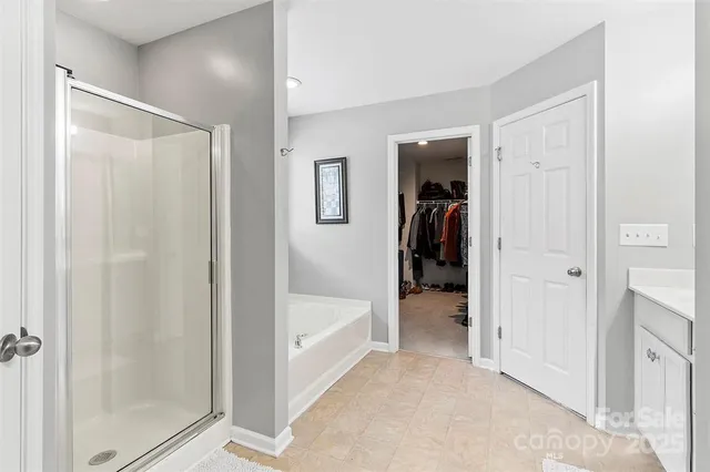 a view of a hallway with closet and bathroom