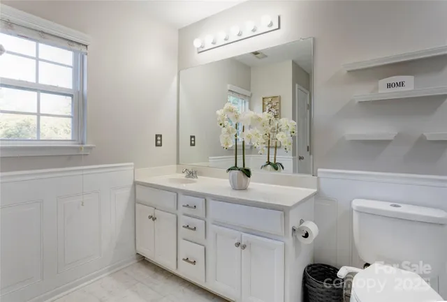 a white toilet sitting next to a bathroom sink
