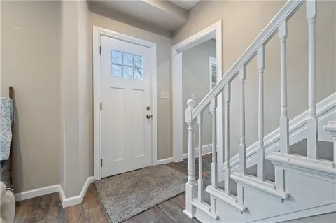 a view of staircase with white walls and furniture