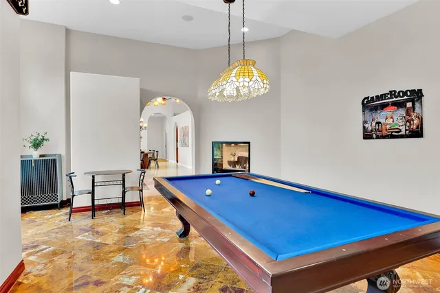 a room with pool table and windows