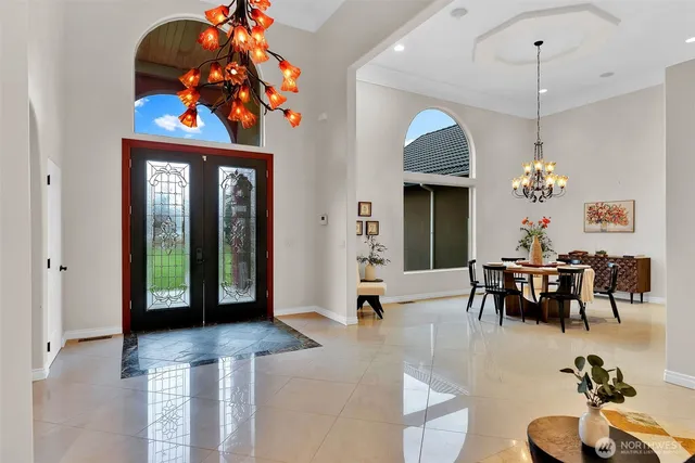a dining room with a table chairs and a chandelier