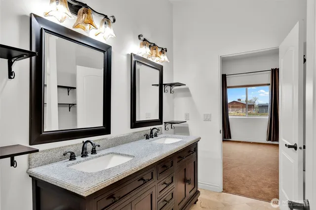 a bathroom with 2 sink and a mirror
