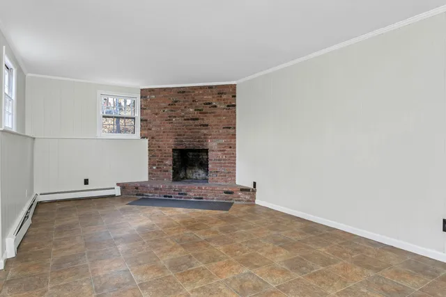 a view of an empty room with a fireplace