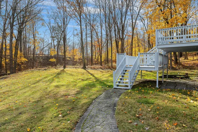 a house with tall trees in front of it
