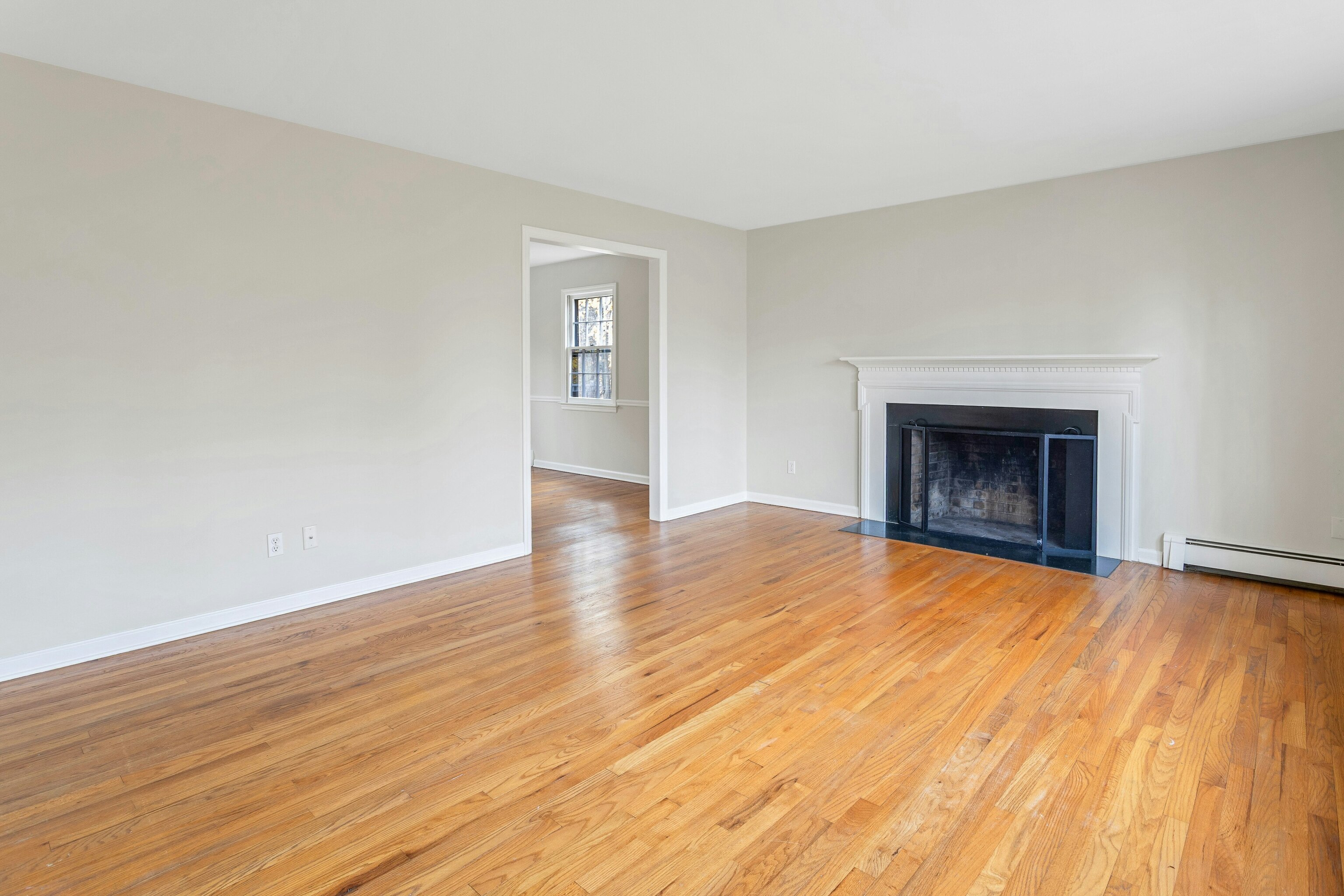 64 Jelliff Mill Road New Canaan, CT 06840 - Photo 5 of 24 a view of an empty room with wooden floor fireplace and a window