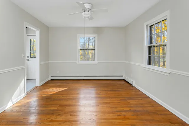 wooden floor in an empty room with a window