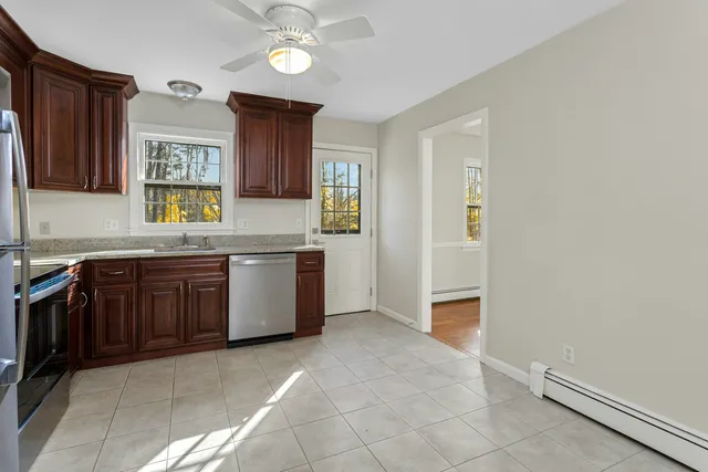 a kitchen with stainless steel appliances granite countertop a stove a sink and a refrigerator