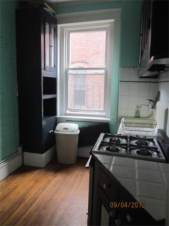 39 Revere Street, Unit 6 Boston, MA 02114 - Photo 2 of 10 a kitchen with a stove a sink and a window