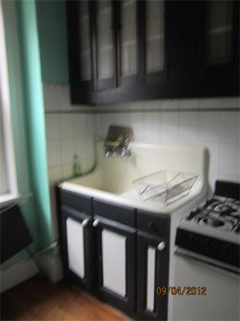 39 Revere Street, Unit 6 Boston, MA 02114 - Photo 3 of 10 a kitchen with a sink a stove and cabinets