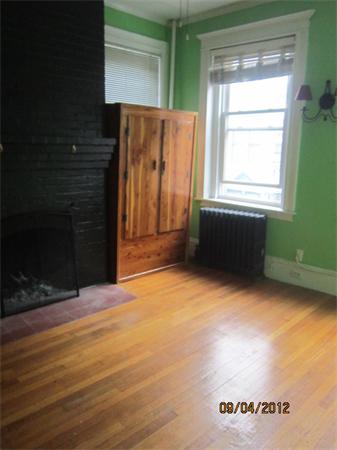 39 Revere Street, Unit 6 Boston, MA 02114 - Photo 5 of 10 a view of an empty room with wooden floor and a window