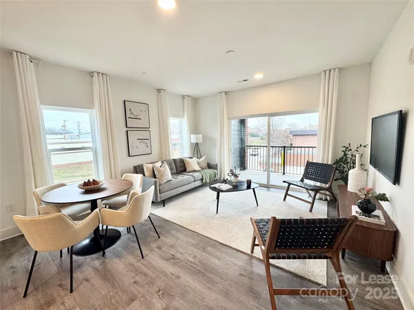 a living room with furniture a table and a window