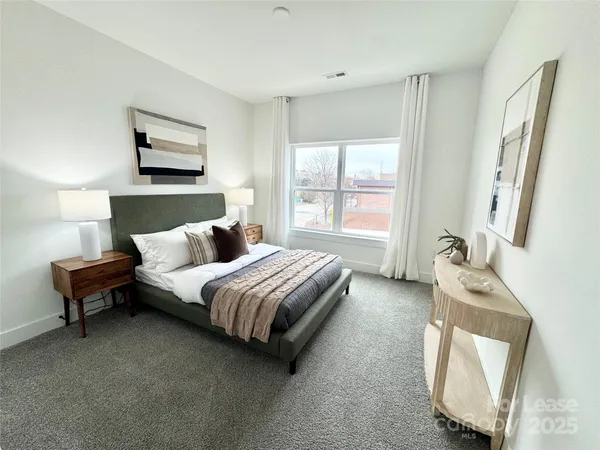 a bedroom with a bed chair and window