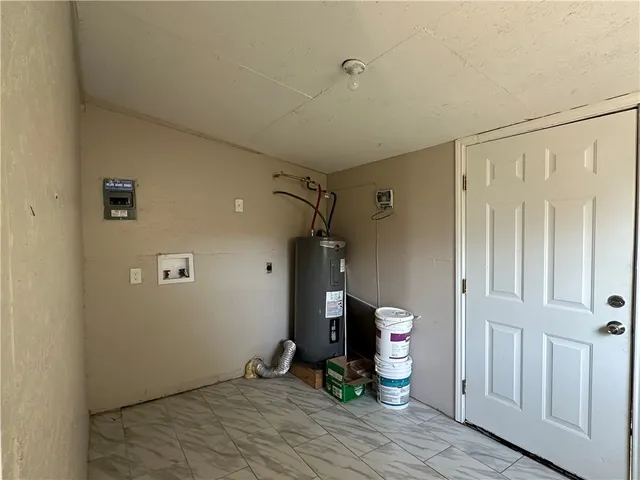 a view of a hallway to the room and wooden floor