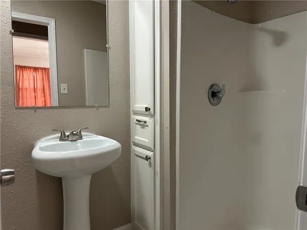 a bathroom with a sink toilet