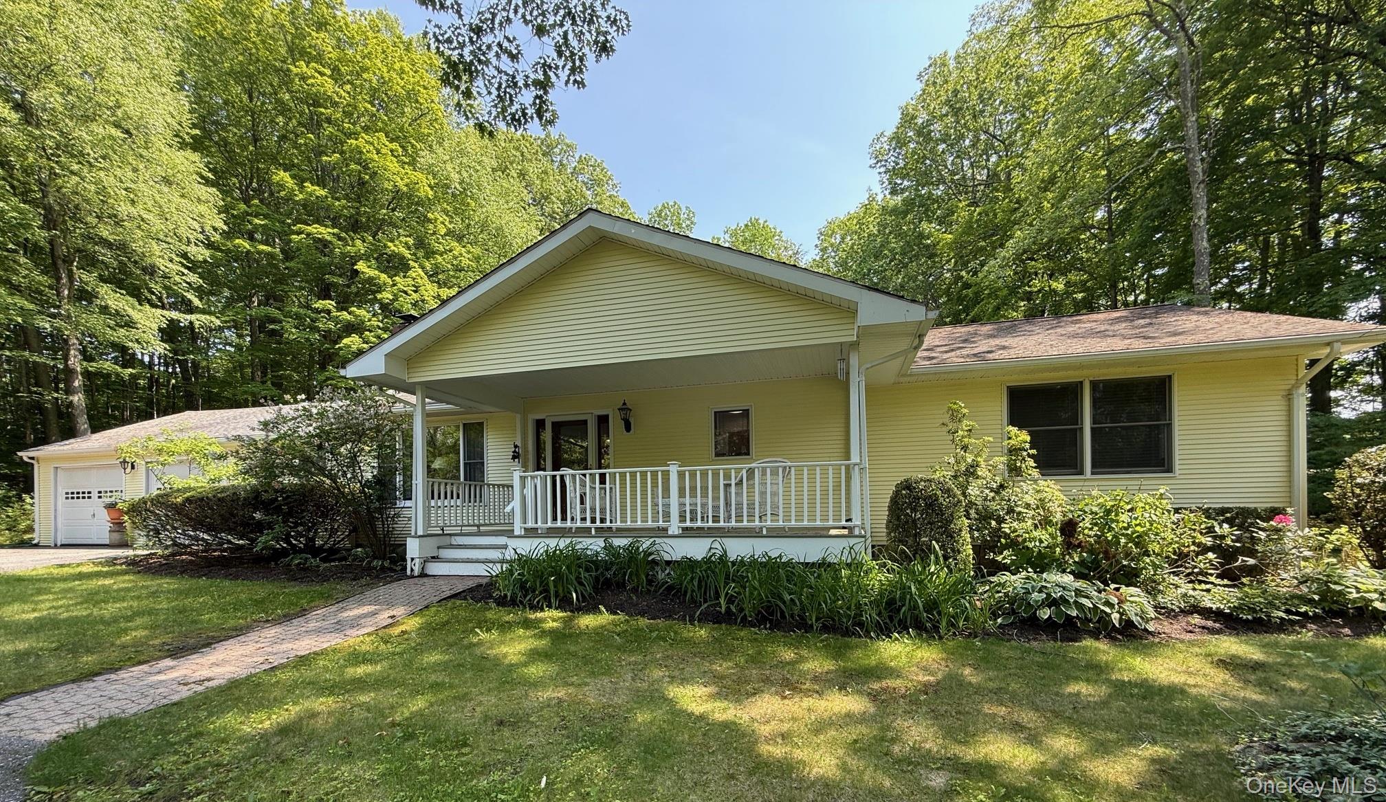 a front view of a house with a yard and porch