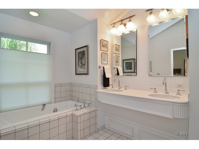 1575 Tower Road Winnetka, IL 60093 - Photo 12 of 21 a bathroom with a double vanity sink mirror and bathtub