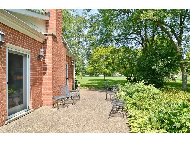 1575 Tower Road Winnetka, IL 60093 - Photo 16 of 21 a backyard of a house with a garden and tree