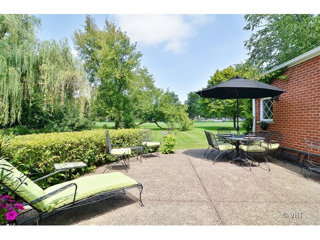 1575 Tower Road Winnetka, IL 60093 - Photo 17 of 21 a view of a patio with a table chairs and a fire pit
