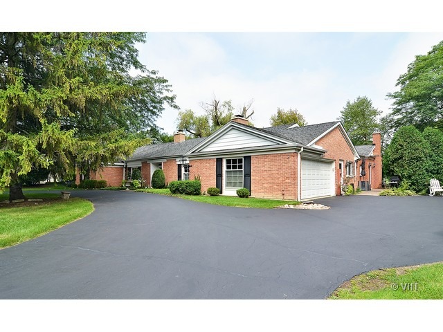 1575 Tower Road Winnetka, IL 60093 - Photo 21 of 21 a front view of a house with a yard and garage