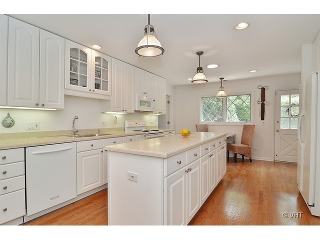 1575 Tower Road Winnetka, IL 60093 - Photo 6 of 21 a kitchen with granite countertop a sink stove and cabinets