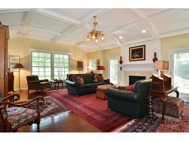 1575 Tower Road Winnetka, IL 60093 - Photo 8 of 21 a living room with furniture a fireplace and a flat screen tv
