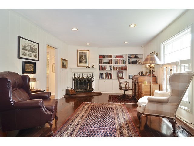 1575 Tower Road Winnetka, IL 60093 - Photo 9 of 21 a living room with furniture a rug and a bookshelf