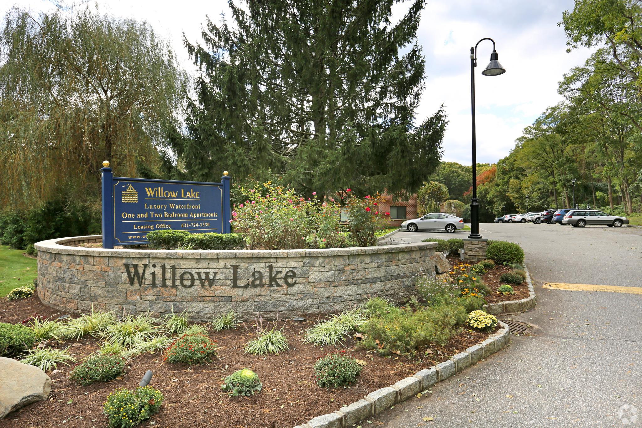 44 Highway 25A, Unit 114 Smithtown, NY 11787 - Photo 1 of 1 Community sign with uncovered parking