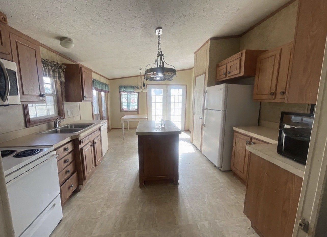 26601 Sun Belt Tool, TX 75143 - Photo 2 of 15 a kitchen with stainless steel appliances granite countertop a stove top oven a sink dishwasher a refrigerator and a dining table with wooden floor