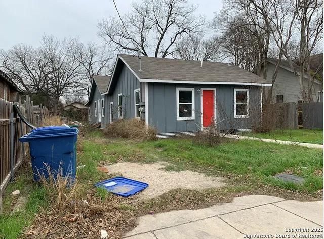 a backyard of a house with barbeque oven and plants