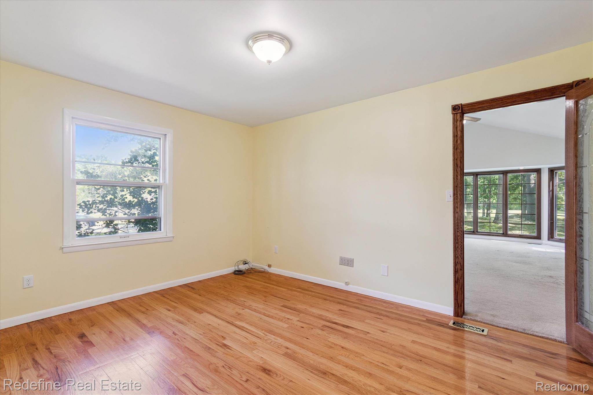 3777 Dorr Road Brighton, MI 48116 - Photo 29 of 77 Spare room featuring light wood-style flooring and plenty of natural light