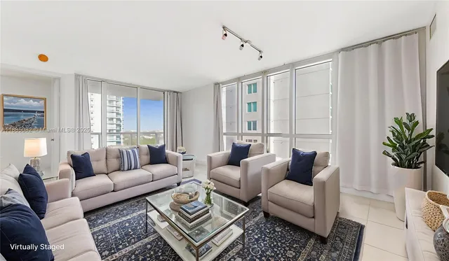 a living room with furniture potted plant and a window