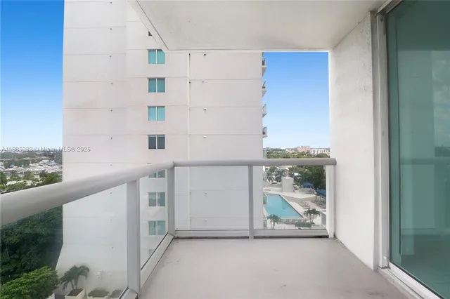 a view of a kitchen with wooden floor and a window