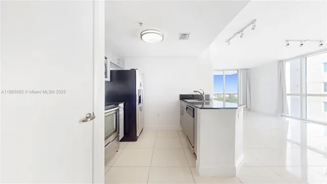 a kitchen with a refrigerator and microwave