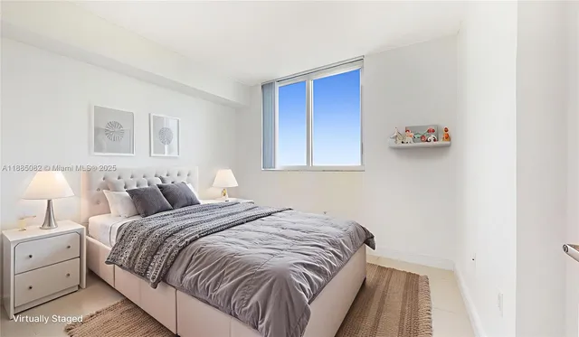 a bedroom with a bed and a lamp with window