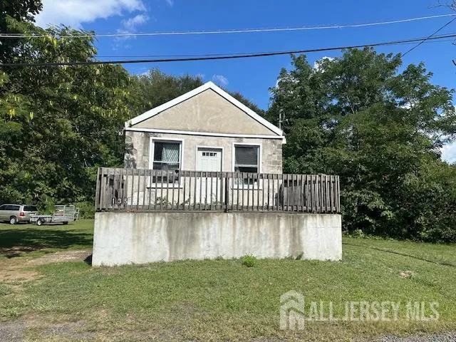 a view of a house with a yard and deck