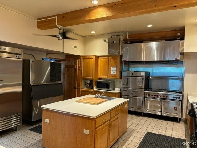 a kitchen with a sink a stove and cabinets