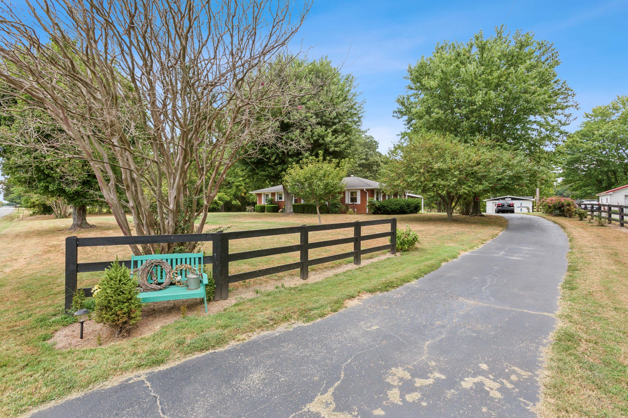 571 Jackson Road Portland, TN 37148 - Photo 2 of 24 a park view with a bench in a garden
