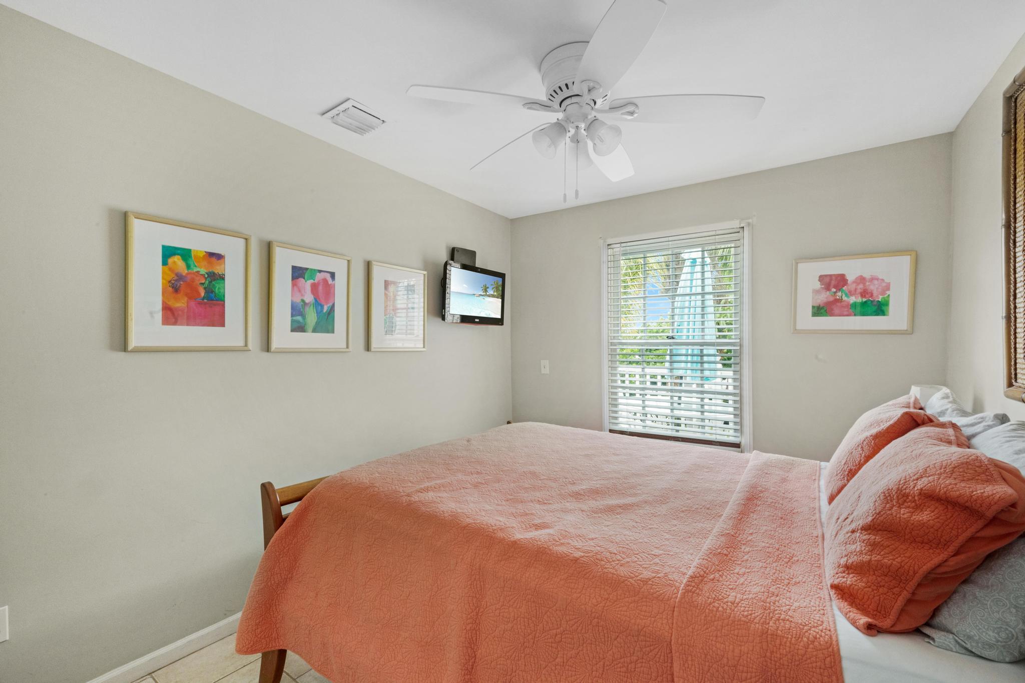 620 Thomas Street, Unit 268 Key West, FL 33040 - Photo 3 of 4 a bedroom with a bed and a chandelier