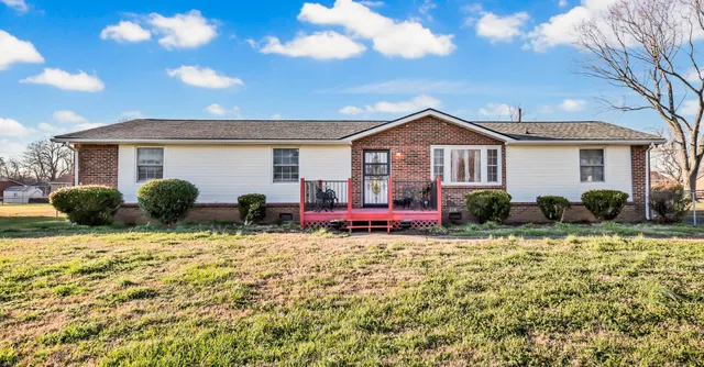 a front view of house with yard and outdoor seating