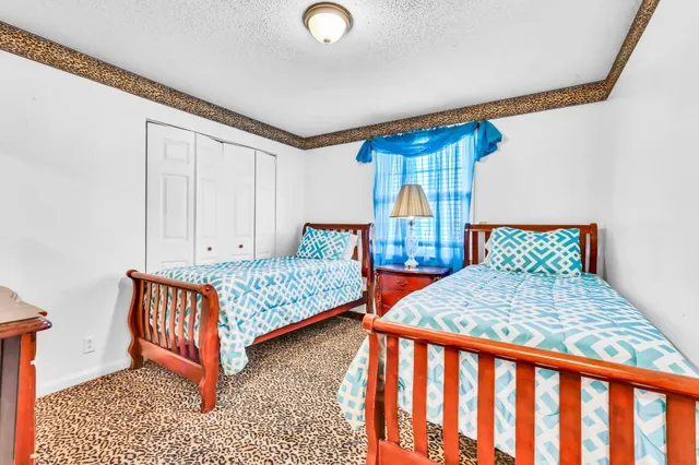 a bedroom with furniture and a window