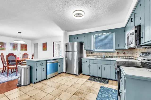 a kitchen with stainless steel appliances granite countertop a sink and cabinets