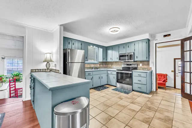 a kitchen with a sink stove and refrigerator