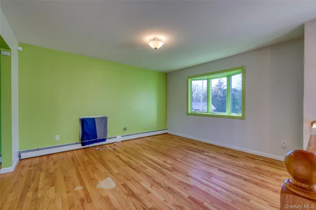 a view of room with window and wooden floor