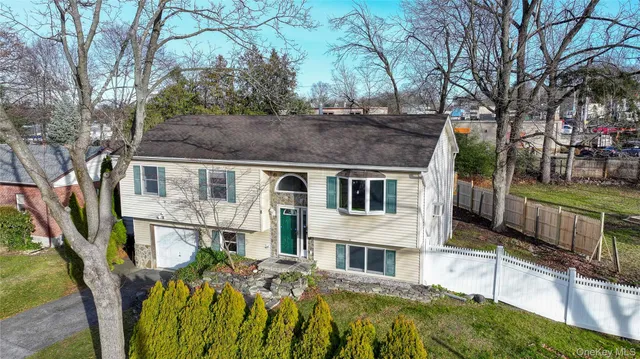 a view of house with outdoor seating area